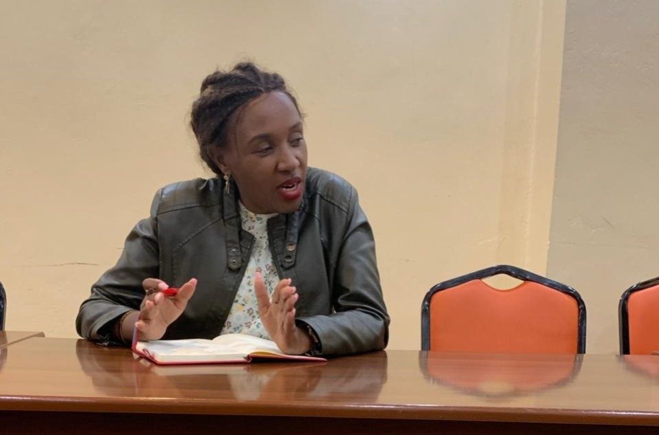 Kenyan business professional reviewing HR policy documents